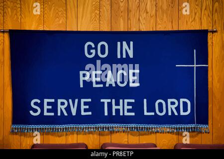 `Go in Peace Serve the Lord` written on Dark Blue Cloth with white cross on the right side, tassels all along the bottom of the cloth. Stock Vector